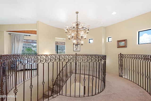 corridor featuring a notable chandelier, carpet, and beam ceiling