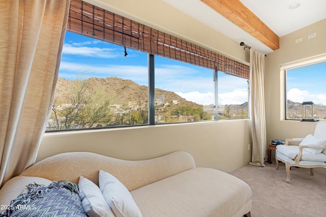 bedroom featuring a mountain view, lofted ceiling with beams, multiple windows, and carpet