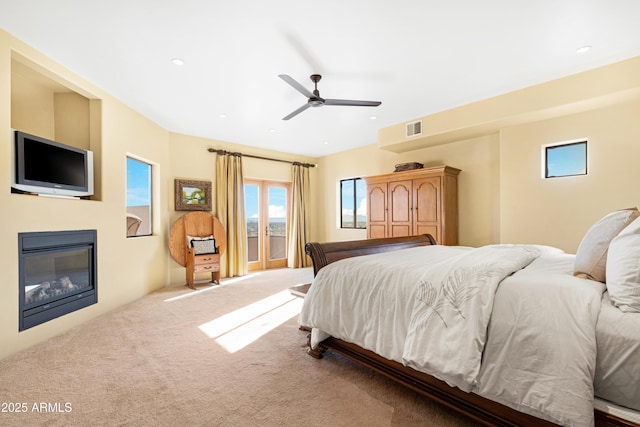 bedroom featuring ceiling fan and light carpet