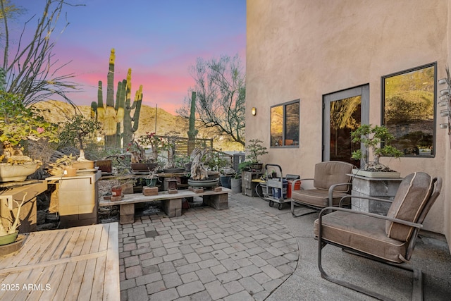 view of patio terrace at dusk