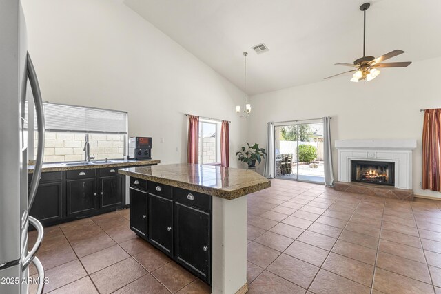 351 N Danyell Dr, Chandler, AZ 85225 - kitchen with dark cabinets, freestanding refrigerator, a sink, high vaulted ceiling, and tile patterned flooring