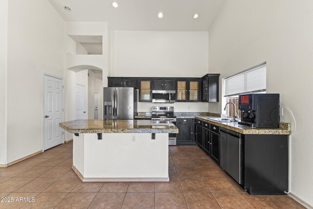 351 N Danyell Dr, Chandler, AZ 85225 - kitchen with stainless steel appliances, a high ceiling, tile counters, a sink, and a kitchen island