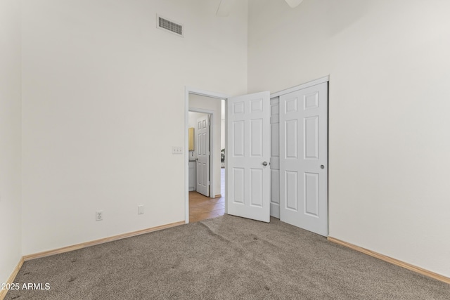 351 N Danyell Dr, Chandler, AZ 85225 - unfurnished bedroom with carpet flooring, baseboards, a towering ceiling, and a closet