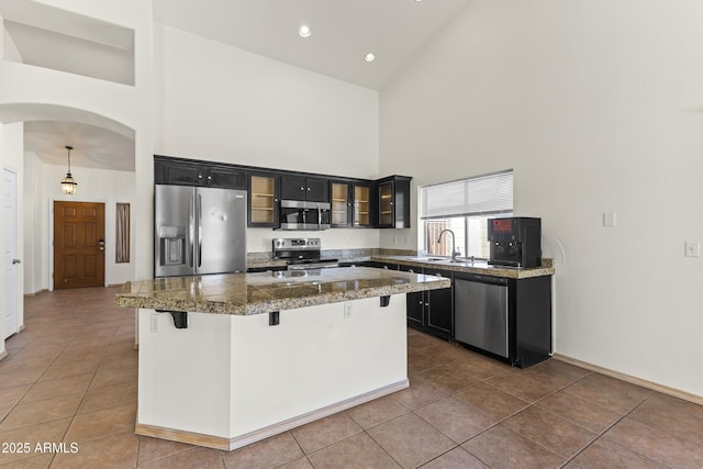 351 N Danyell Dr, Chandler, AZ 85225 - kitchen featuring appliances with stainless steel finishes, high vaulted ceiling, tile countertops, dark cabinets, and arched walkways