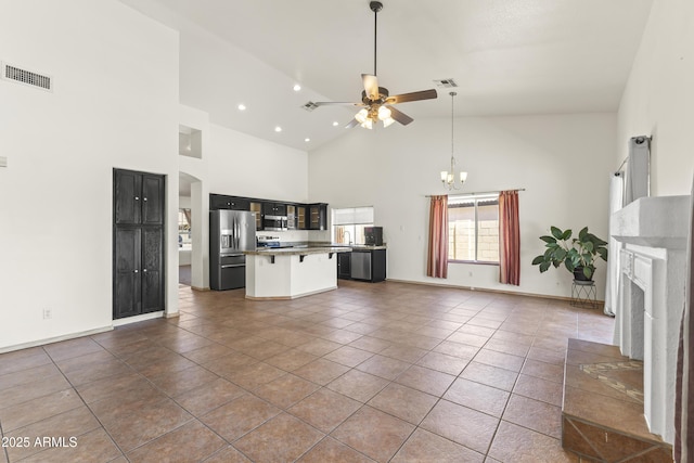 351 N Danyell Dr, Chandler, AZ 85225 - unfurnished living room featuring ceiling fan, a chandelier, high vaulted ceiling, a fireplace, and arched walkways