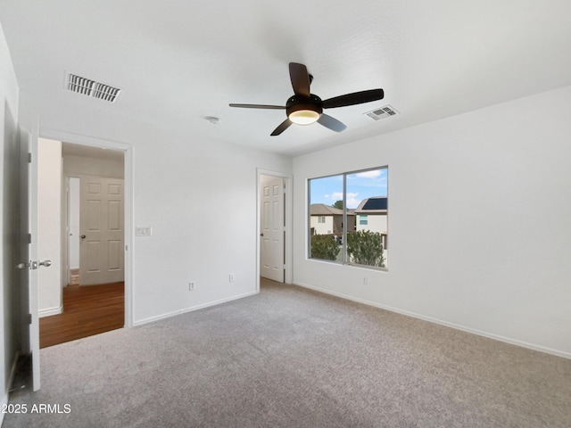 unfurnished bedroom featuring carpet, visible vents, and baseboards