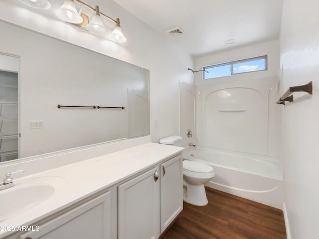 full bath featuring visible vents, toilet, shower / bath combination, wood finished floors, and vanity