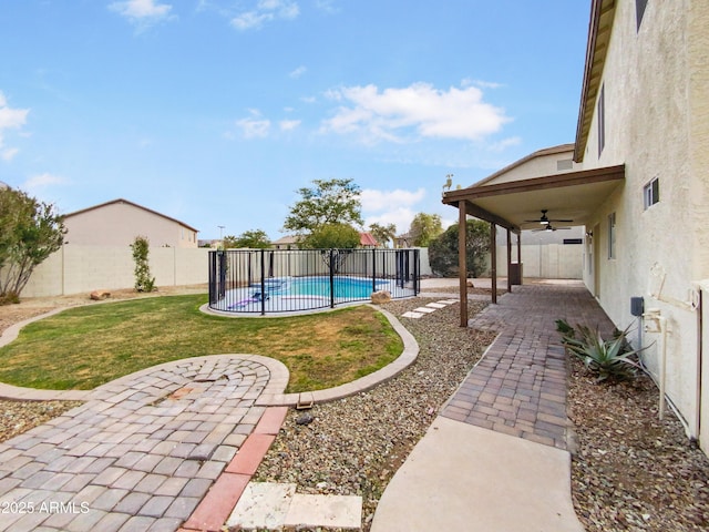 view of yard with a patio, a ceiling fan, a fenced in pool, and a fenced backyard