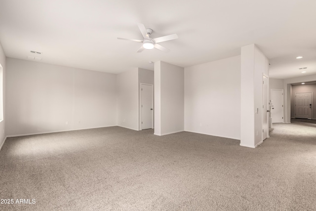 unfurnished room featuring ceiling fan and carpet