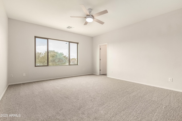 carpeted spare room with ceiling fan