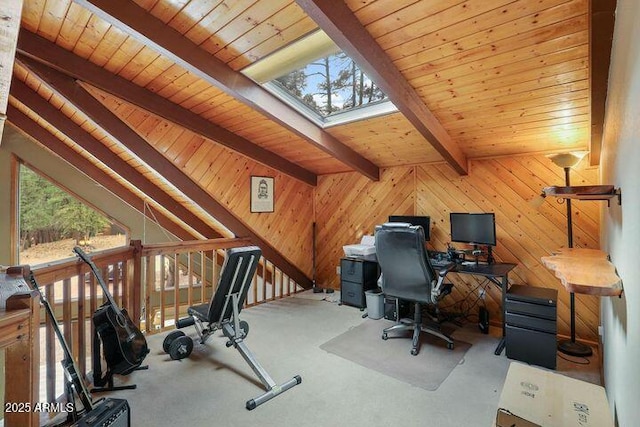 carpeted home office featuring vaulted ceiling with skylight, wooden ceiling, and wooden walls