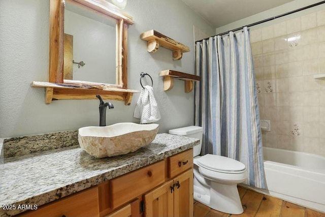 full bathroom featuring wood finished floors, vanity, toilet, and shower / bath combo with shower curtain