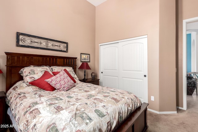 bedroom with a closet, baseboards, and carpet floors