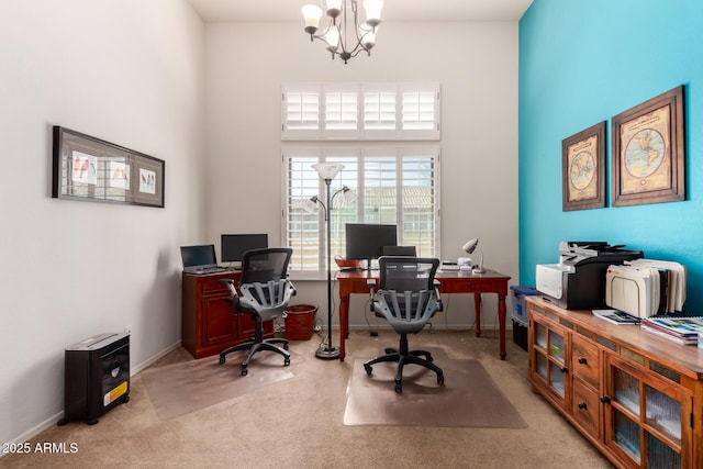 carpeted office space with baseboards, a high ceiling, and an inviting chandelier