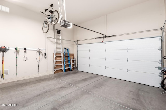 garage featuring visible vents and a garage door opener