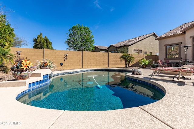 view of swimming pool with a fenced in pool, a patio, and a fenced backyard