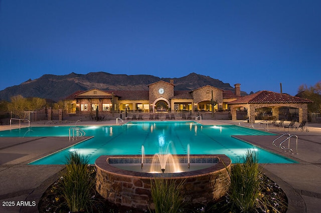 pool featuring a gazebo, a mountain view, a patio area, and fence