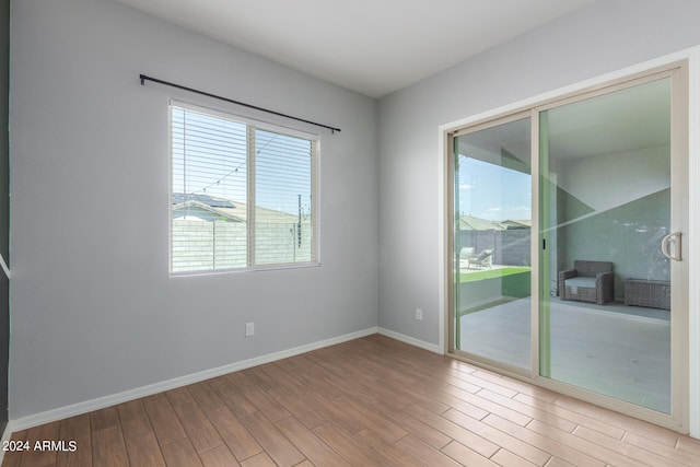 empty room with light hardwood / wood-style flooring