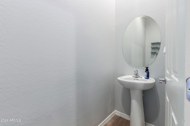 bathroom with hardwood / wood-style floors