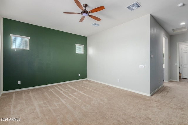 carpeted spare room featuring ceiling fan