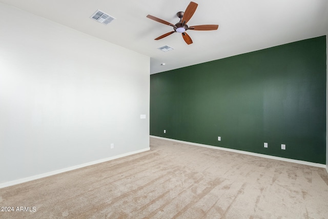 carpeted spare room with ceiling fan