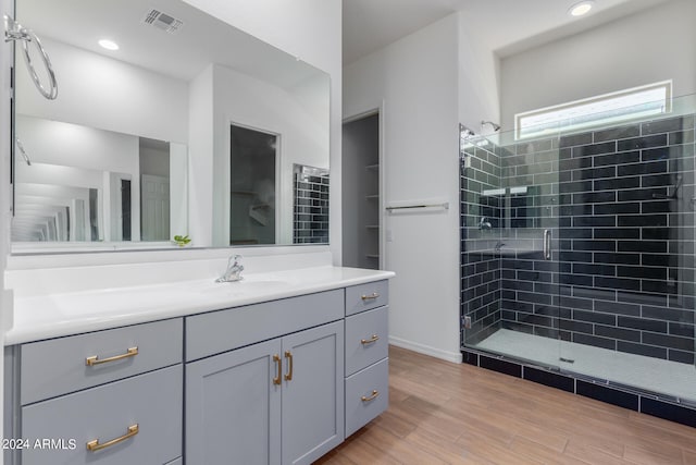 bathroom with an enclosed shower and vanity