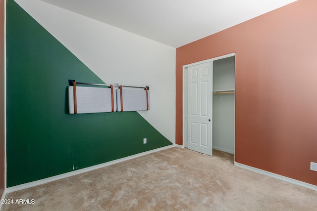 unfurnished bedroom with carpet and a closet