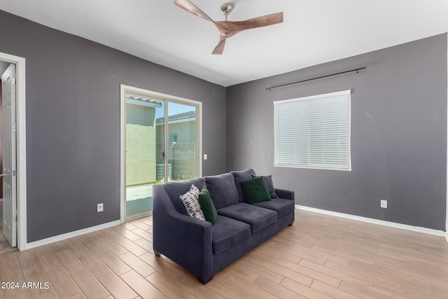 living room with light wood-type flooring and ceiling fan