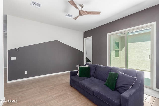 living room featuring ceiling fan and light hardwood / wood-style flooring