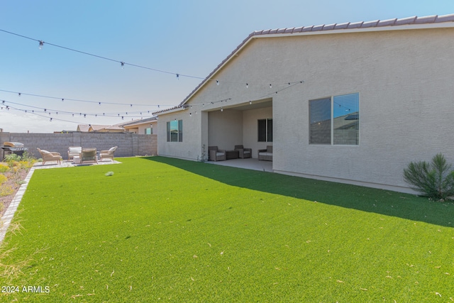 rear view of property with a yard and a patio