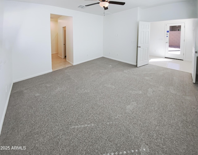 spare room featuring baseboards, carpet, visible vents, and ceiling fan