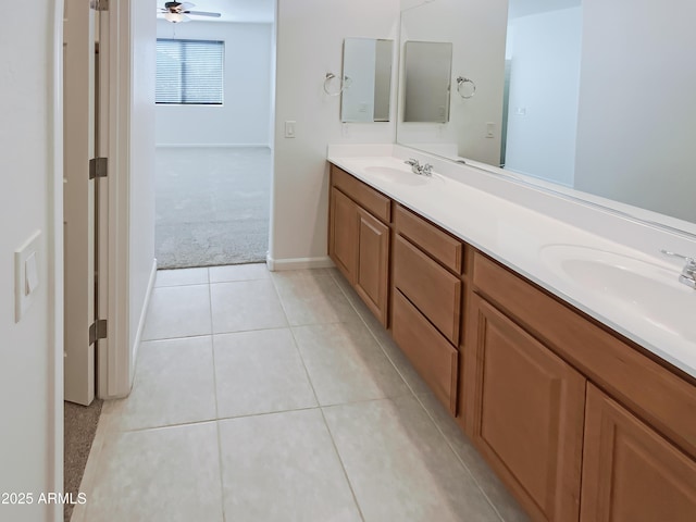 bathroom with ceiling fan, tile patterned floors, double vanity, and a sink