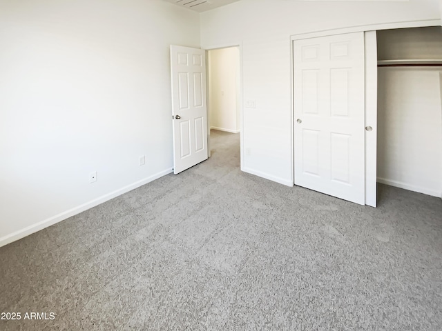 unfurnished bedroom with a closet, baseboards, and carpet floors