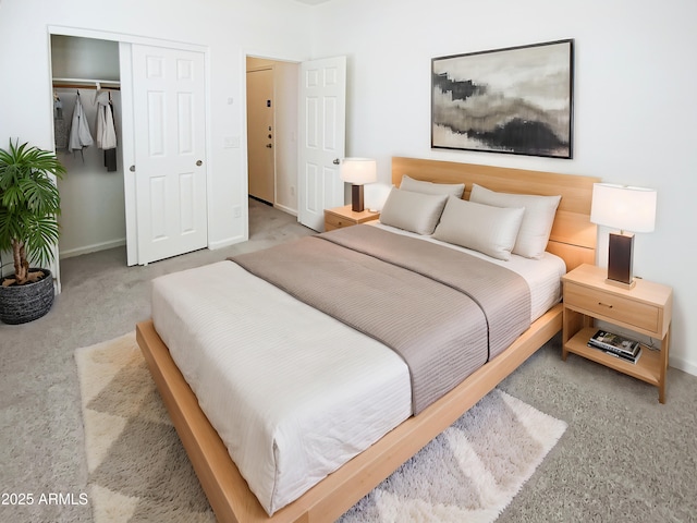 carpeted bedroom featuring baseboards and a closet