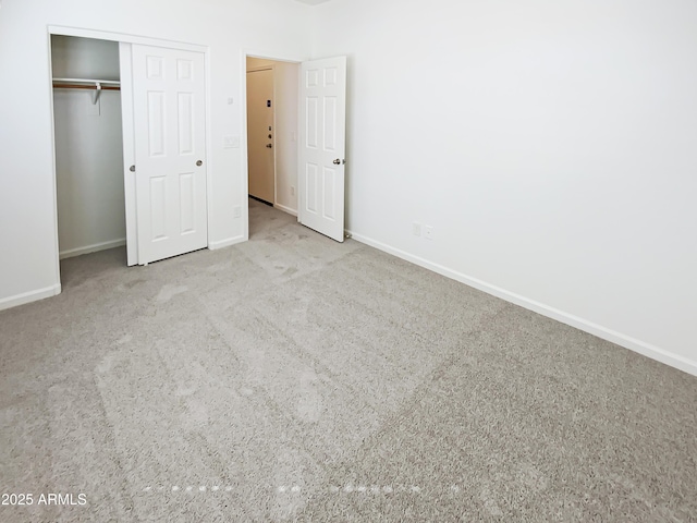 unfurnished bedroom featuring a closet, baseboards, and carpet floors