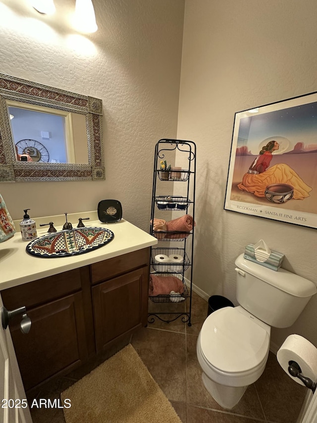 4116 E Sierra Sunset Trl, Cave Creek, AZ 85331 - half bath with a textured wall, toilet, vanity, baseboards, and tile patterned floors