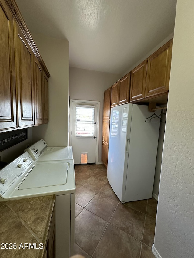 4116 E Sierra Sunset Trl, Cave Creek, AZ 85331 - laundry area featuring washer and dryer, dark tile patterned flooring, and cabinet space