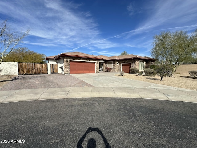 4116 E Sierra Sunset Trl, Cave Creek, AZ 85331 - prairie-style home with an attached garage, stone siding, driveway, and fence