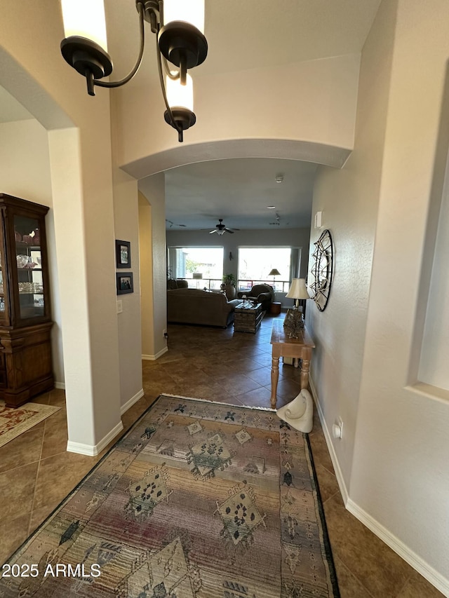 4116 E Sierra Sunset Trl, Cave Creek, AZ 85331 - hall featuring arched walkways, dark tile patterned floors, and baseboards
