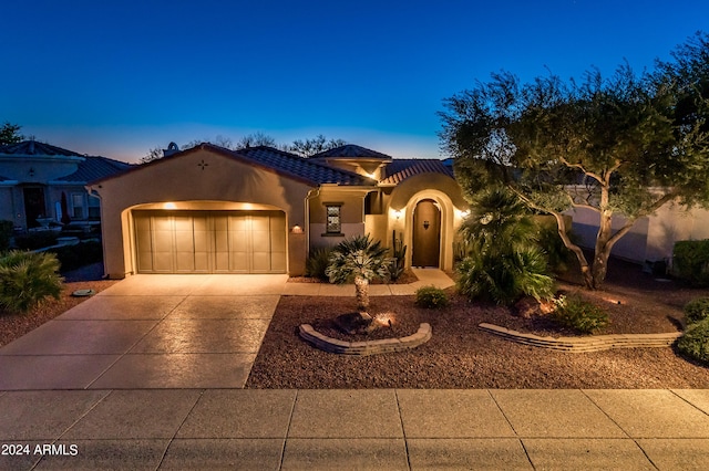 mediterranean / spanish home with a garage