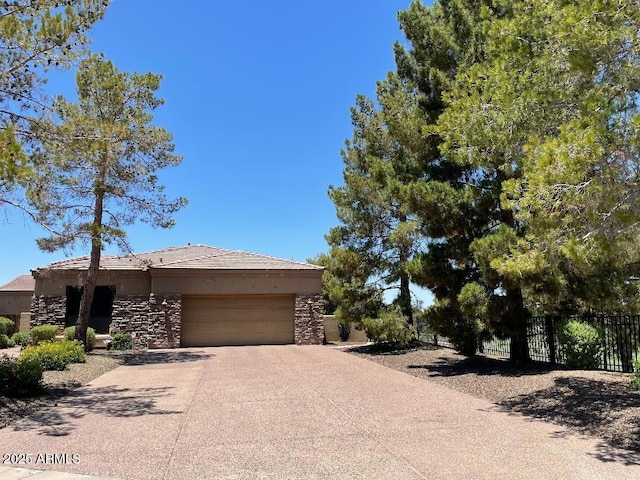 6832 S 38th Pl S, Phoenix, AZ 85042 - view of front of property featuring an attached garage, fence, stone siding, and driveway