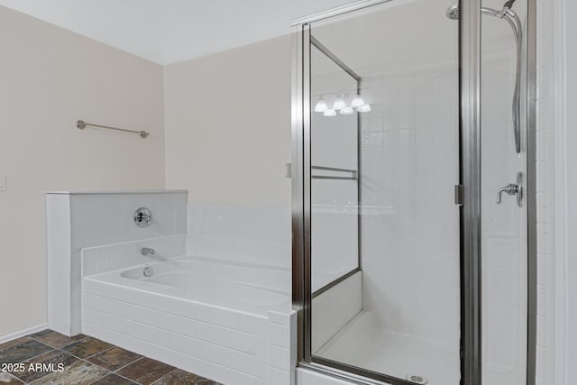 bathroom with a stall shower and a garden tub