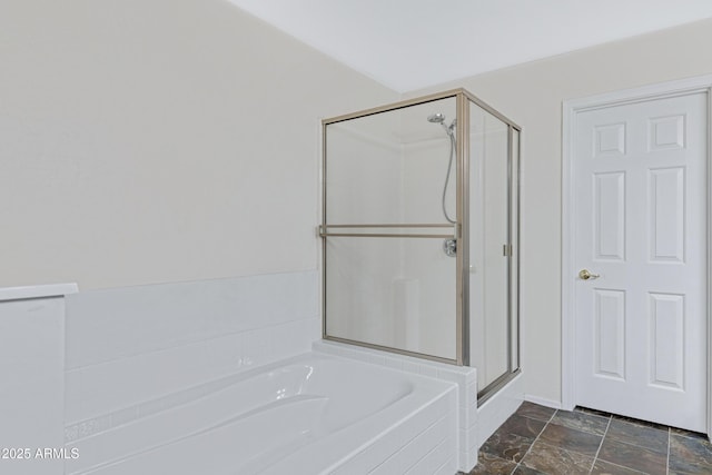 bathroom featuring a garden tub and a shower stall