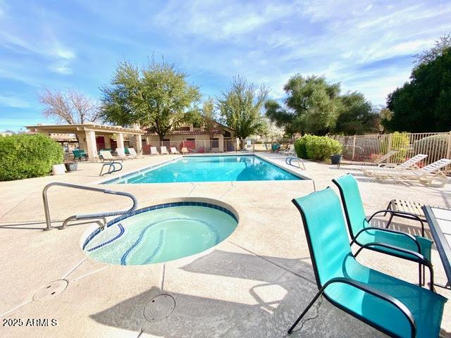 view of pool with a patio and a hot tub