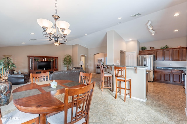 dining room featuring a chandelier and vaulted ceiling