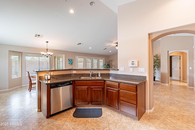 kitchen featuring kitchen peninsula, pendant lighting, dishwasher, sink, and light tile patterned floors