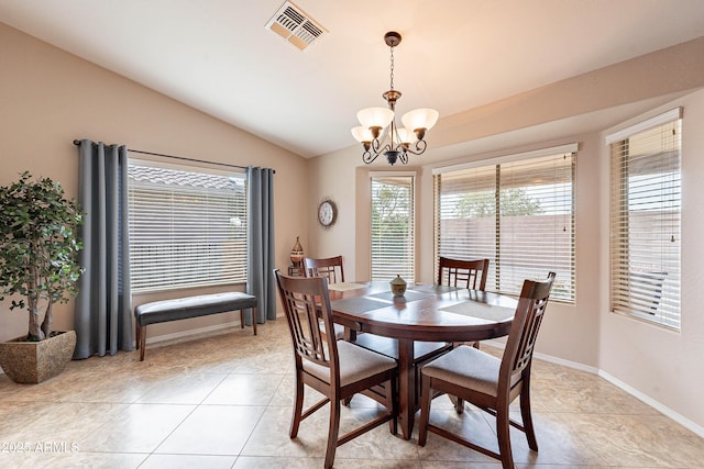 dining space with light tile patterned flooring, a notable chandelier, and vaulted ceiling