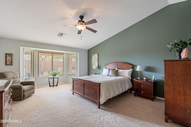 carpeted bedroom with ceiling fan and vaulted ceiling