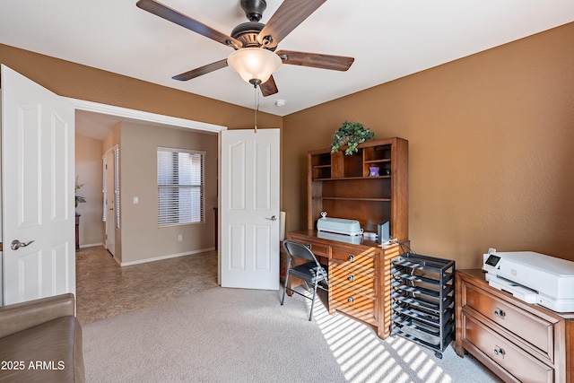 carpeted office featuring ceiling fan