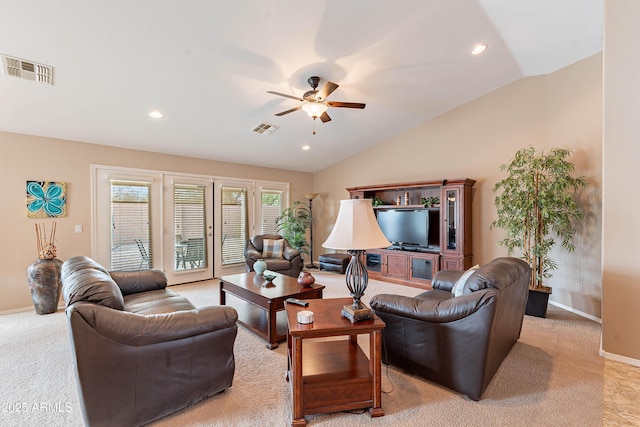 living room featuring ceiling fan, light colored carpet, and vaulted ceiling